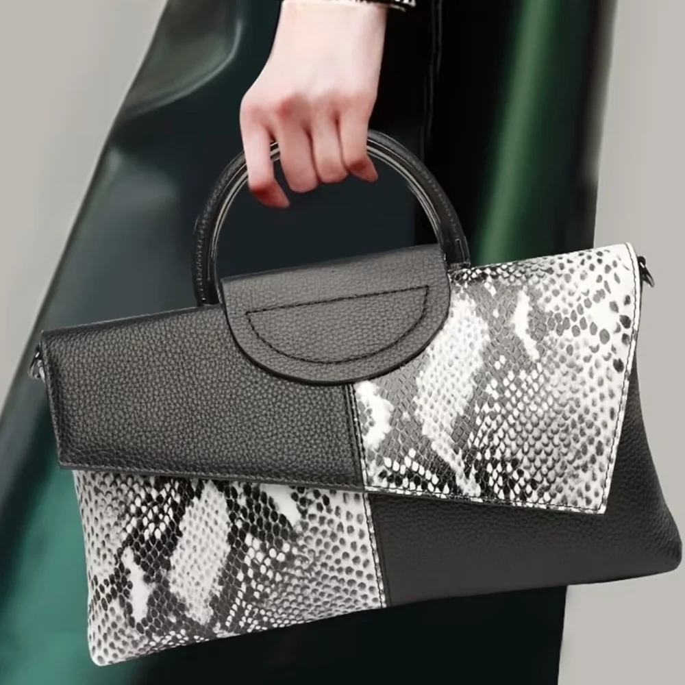 Luce black and white snakeskin clutch bag